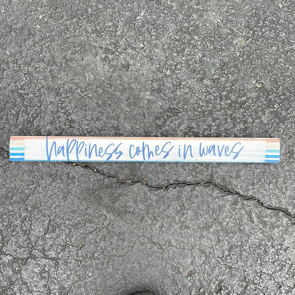 Happiness comes in waves sign